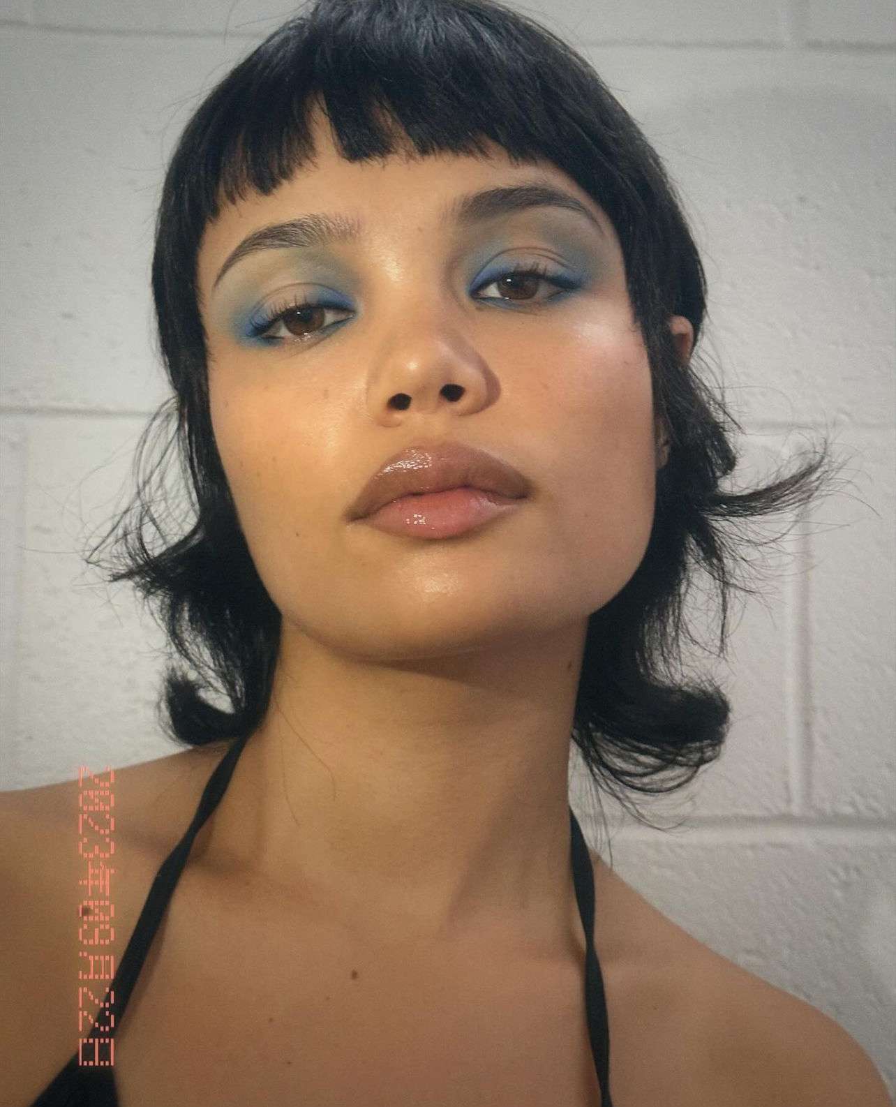 model is wearing a smoky denim blue eyeshadow look