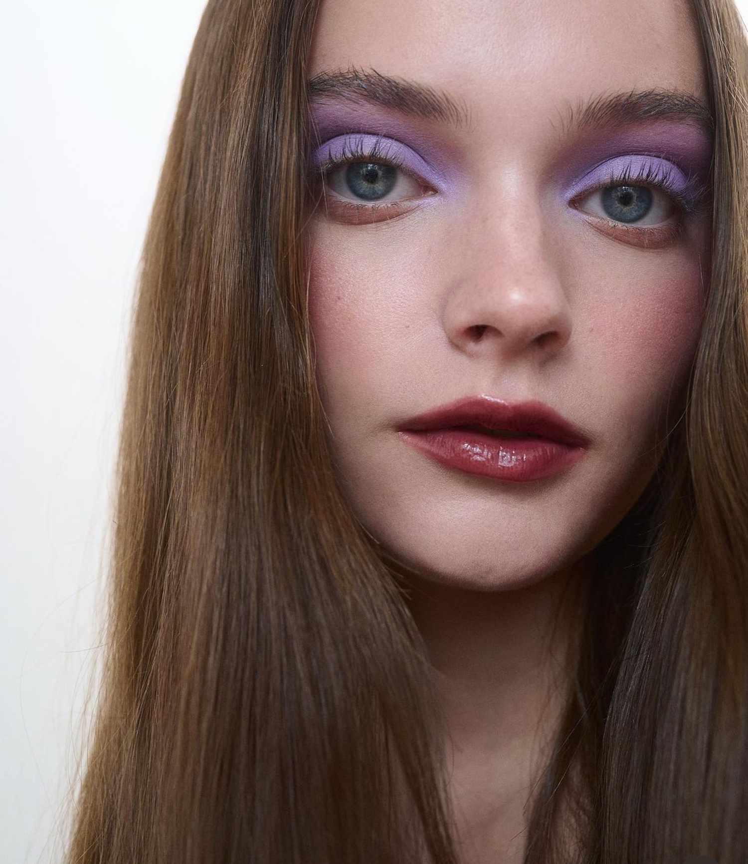 model is wearing a vivid matte lilac eyeshadow look