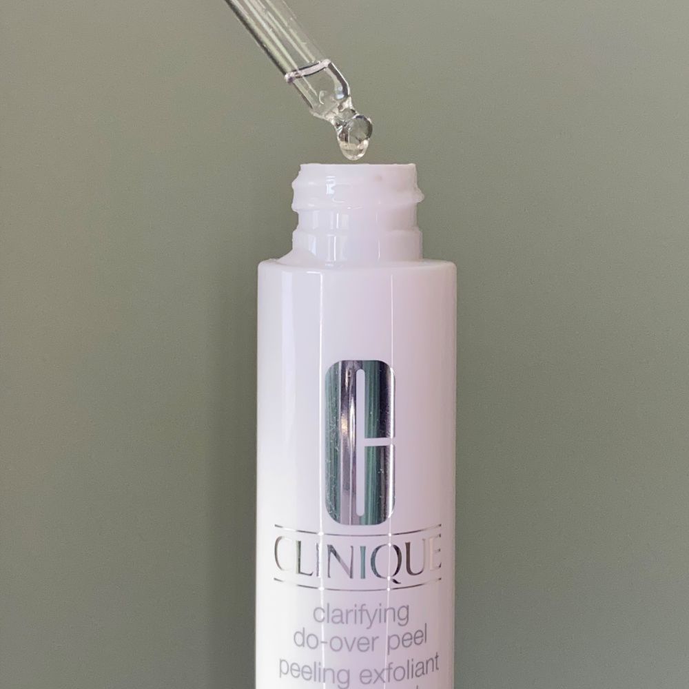 Clinique Clarifying Do-Over Peel dropped suspended above bottle