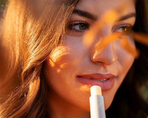 Woman applying lip balm