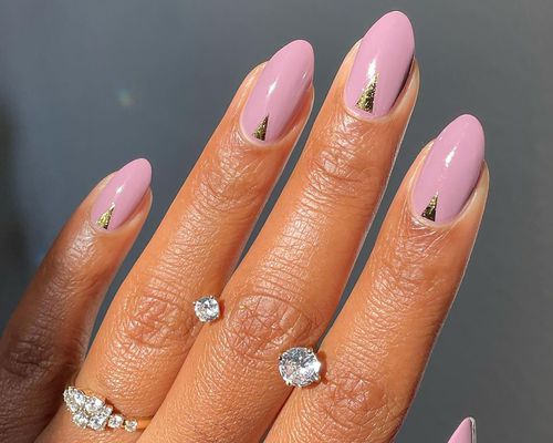 Close up of a mauve manicure on a darker-skinned hand