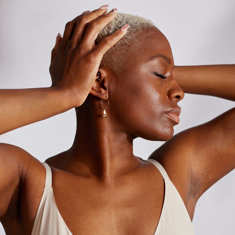 woman with bare skin and blonde buzz cut