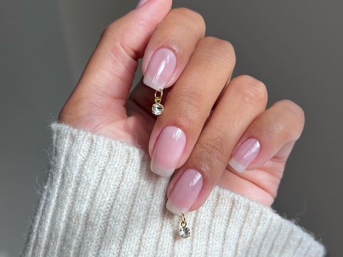 a glossy manicure with a diamond piercing