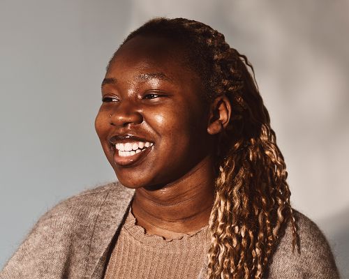 Happy woman looking away against white background