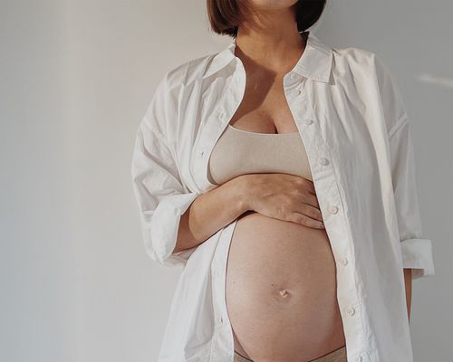 pregnant woman in white shirt