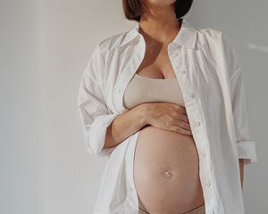 pregnant woman in white shirt