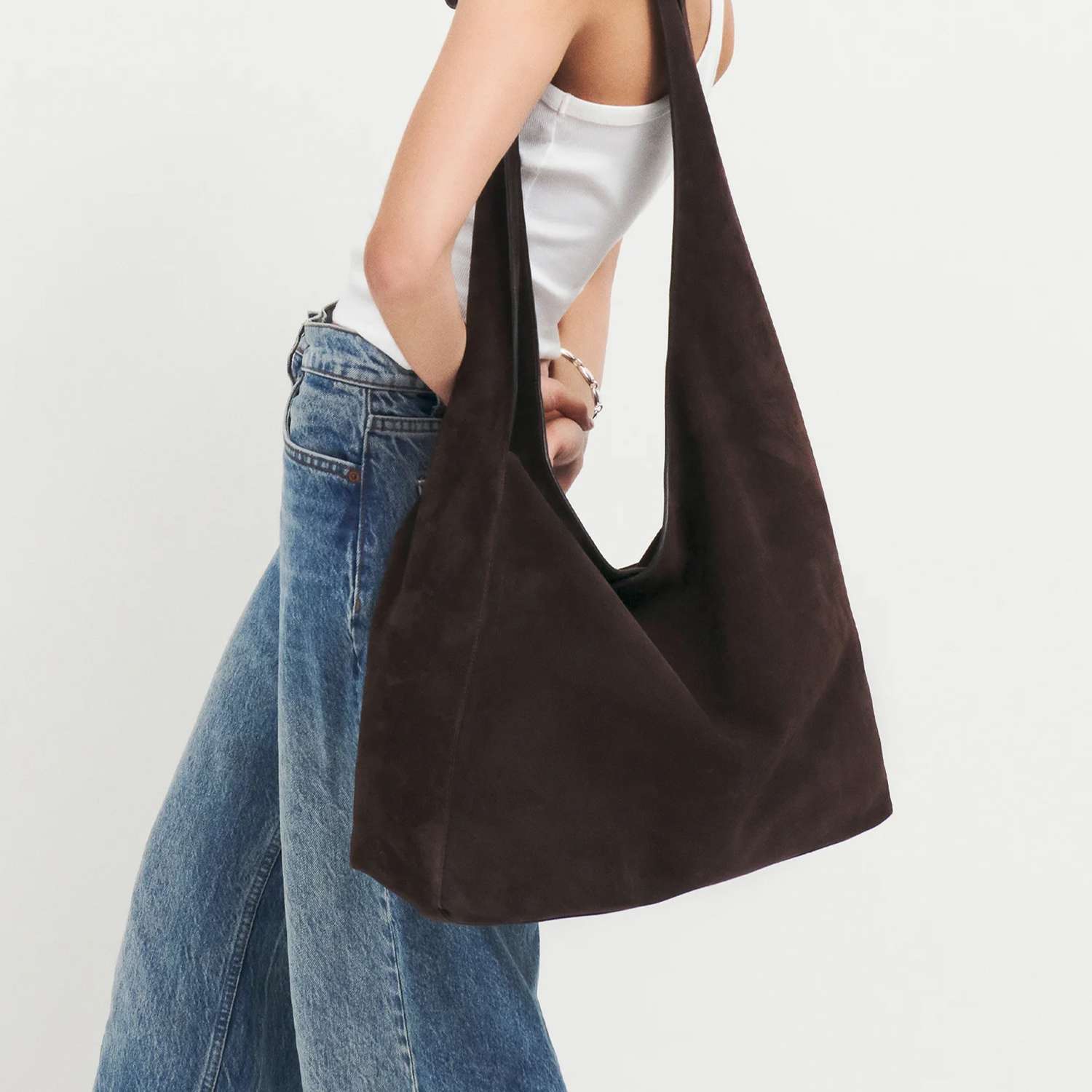 Reformation Oversized Vittoria Tote bag in black on model wearing white tank top and jeans