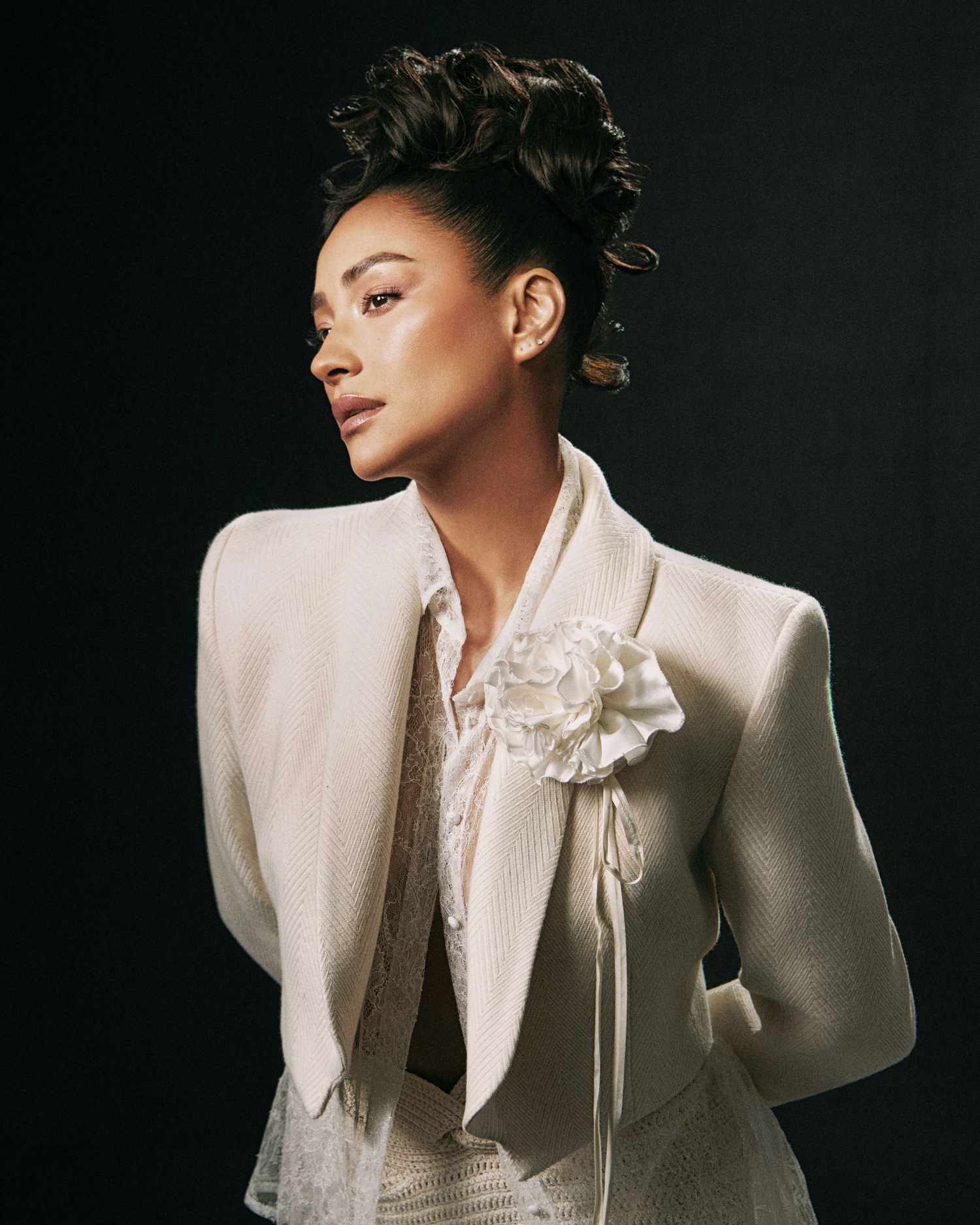 Shay Mitchell curly updo white blazer