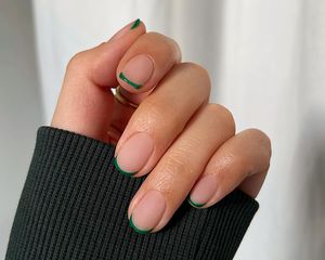 A short French manicure with green tips