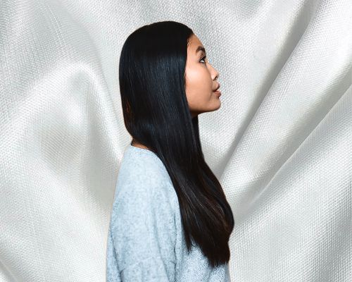 woman with smooth long hair on silky background