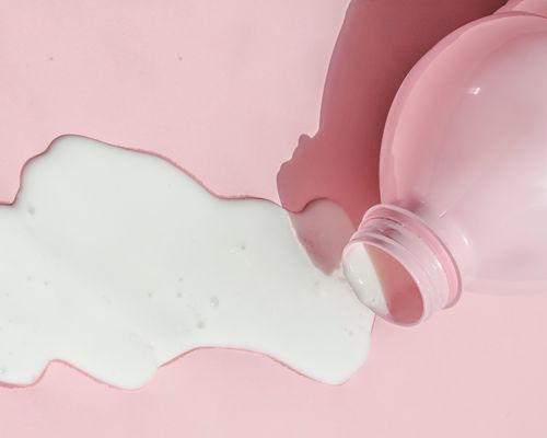 spilled milk on a pink background