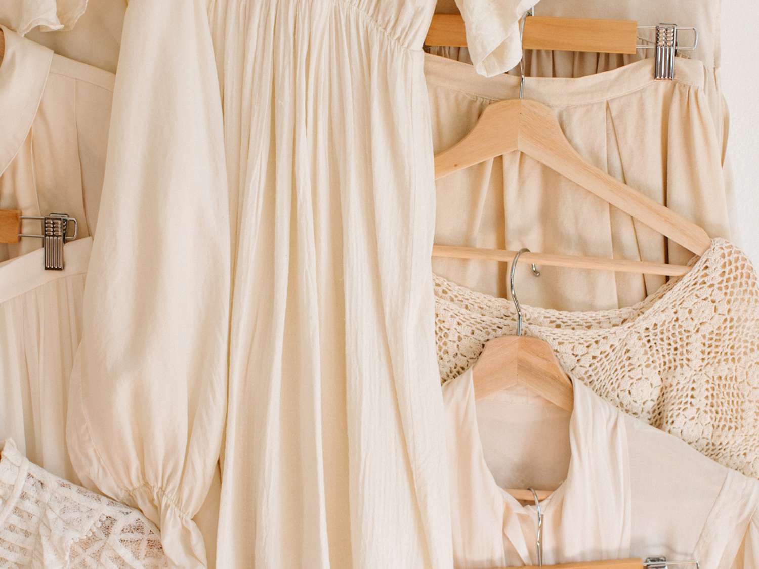 Cream-colored clothing items on neutral hangars