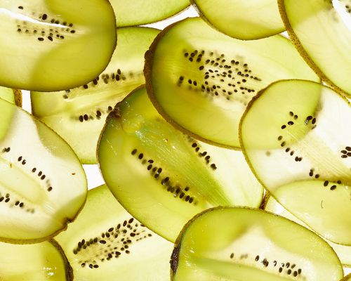 kiwis lined up on white background