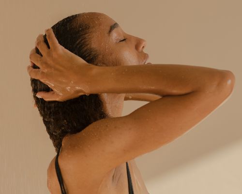 woman patting wet hair with hands