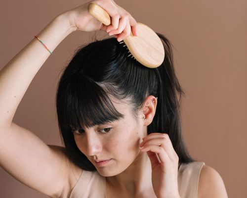 Close up of a woman brushing her hair