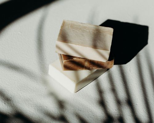 bars of soap stacked on shadowy background