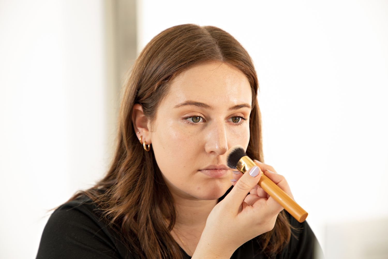 Person applying the foundation with a brush