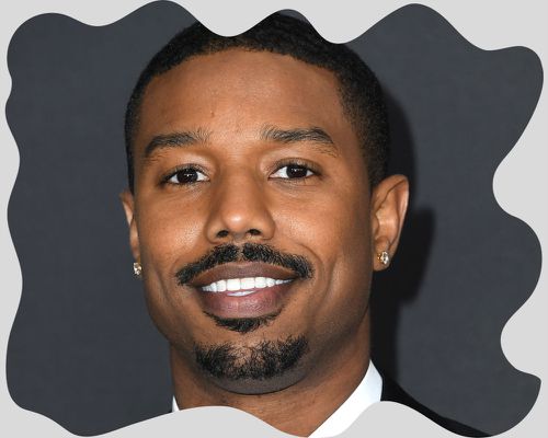 Close up of the actor Michael B. Jordan, wearing a thin mustache. 