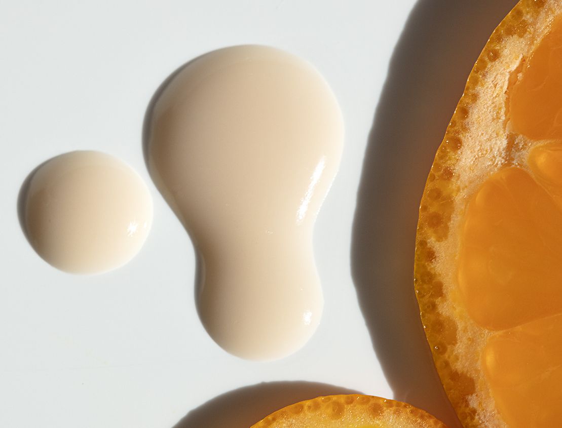 skincare droplet next to cut orange