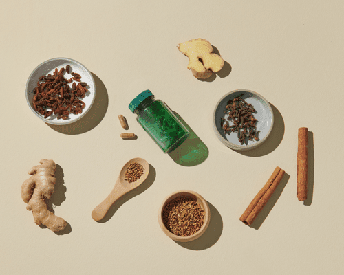 Composed image of scattered ginger, cinnamon sticks, supplements, ashwagandha, etc. 