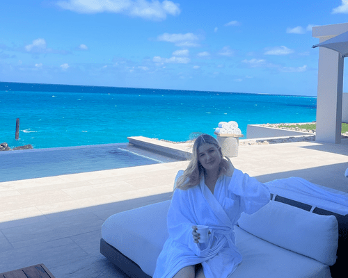 the author in a robe at the beach