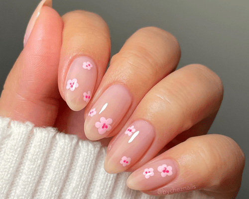 Close up of nude short nails with abstract cherry blossoms. 