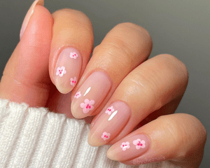 Close up of nude short nails with abstract cherry blossoms. 