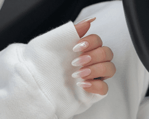 A hand with white ombrÃ© chrome nails