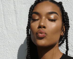 Model with brown braids and copper shimmer eyeshadow