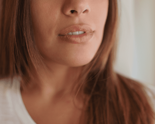 A woman's lower face showing her nose and lips