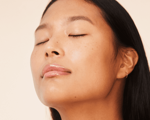 Close up of a woman's face with glowy skin