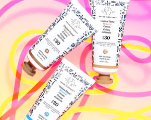 Drunk Elephant Umbra Mineral Cream sunscreens on a colorful background