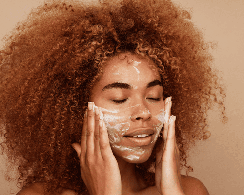 Close up of a woman's face as she exfoliates