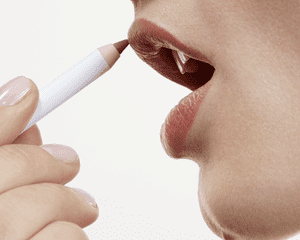 A woman applying the Glossier Lip Line Enhancing Pencil