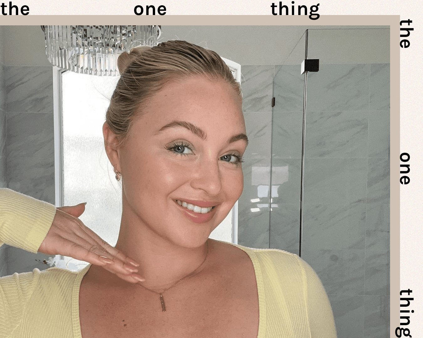 iskra lawrence wearing slicked back bun and yellow top and neutral makeup