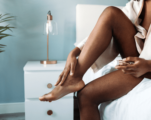 A woman applying a product to her bare legs