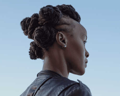 Back view of a model with Bantu knots, showing of four ear piercings. 