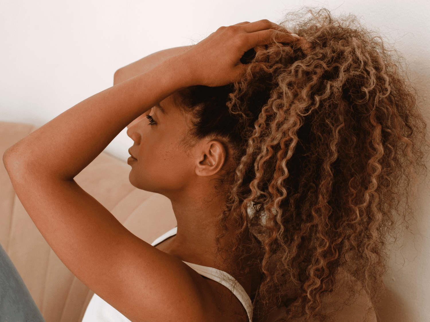 Close up of woman touching her curly hair