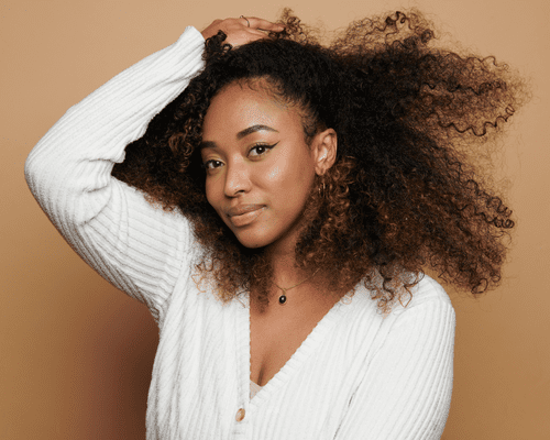 Close up of a model with curly hair. 