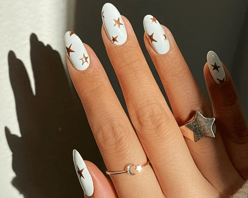 white manicure with gold stars