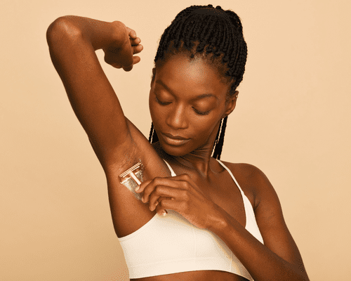 Close up of a model shaving her armpit.