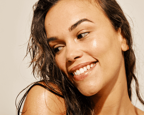 Close up of a woman's face with glowing skin