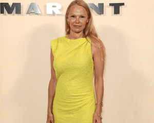 Pamela Anderson wearing no makeup and a yellow dress