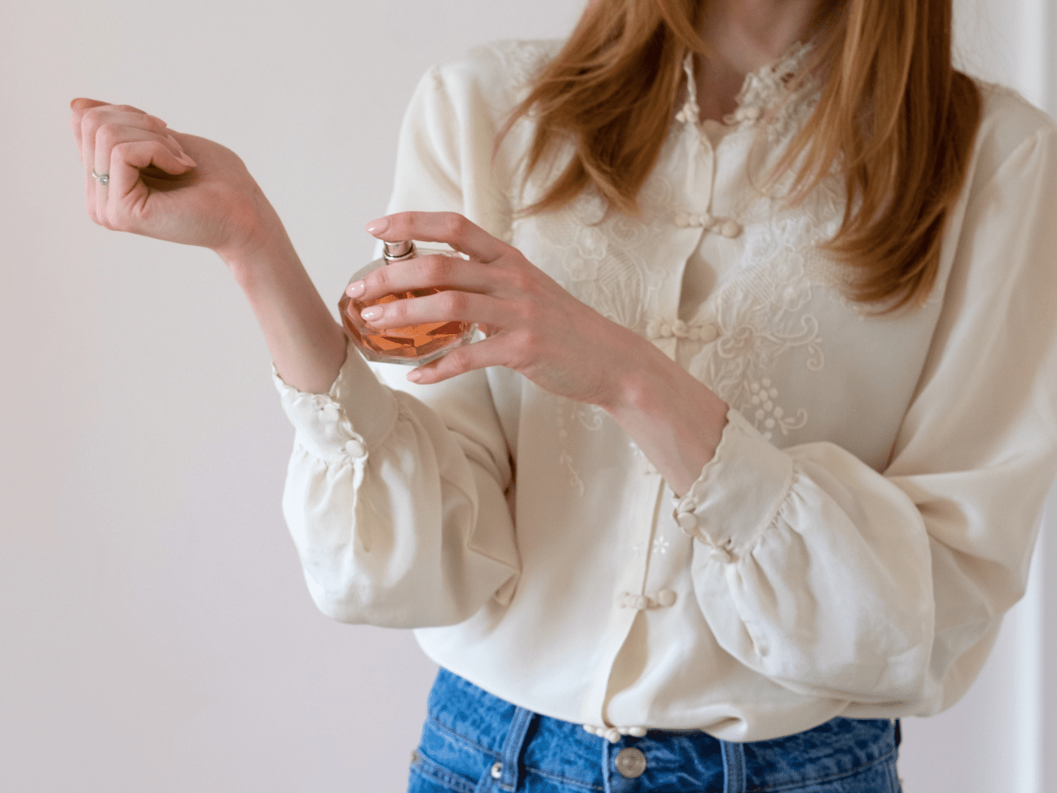 A woman spraying perfume on her wrist