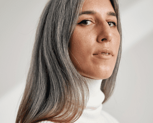 Close up of a woman with grey hair. 