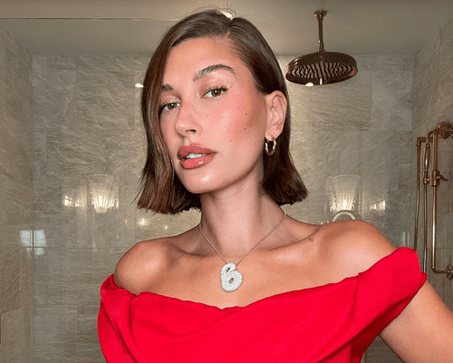 hailey bieber wearing red dress and natural makeup 