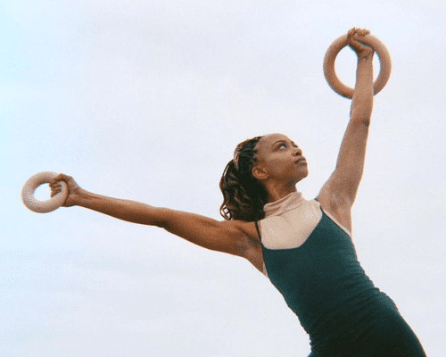 woman holding weighted bala hoops