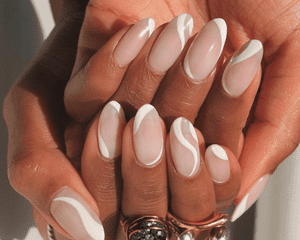 woman with white and pink swirly manicure