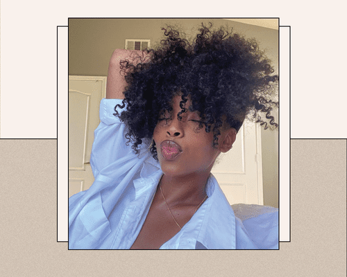 black woman with natural curly textured hair in button down shirt