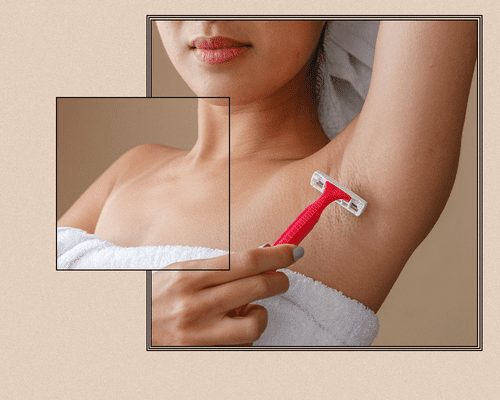 Woman shaving underarms